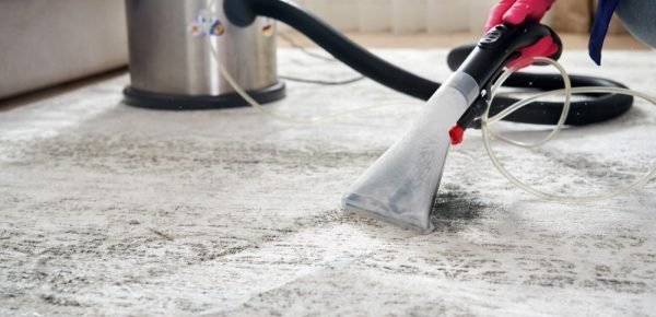 human-cleaning-carpet-living-room-using-vacuum-cleaner-home-min